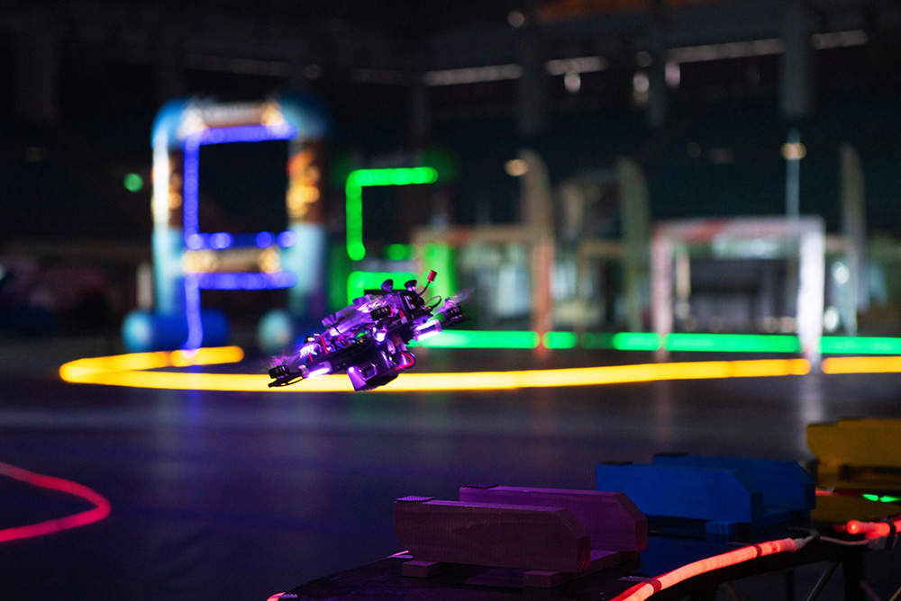A drone flying through the LED-lit racetrack.