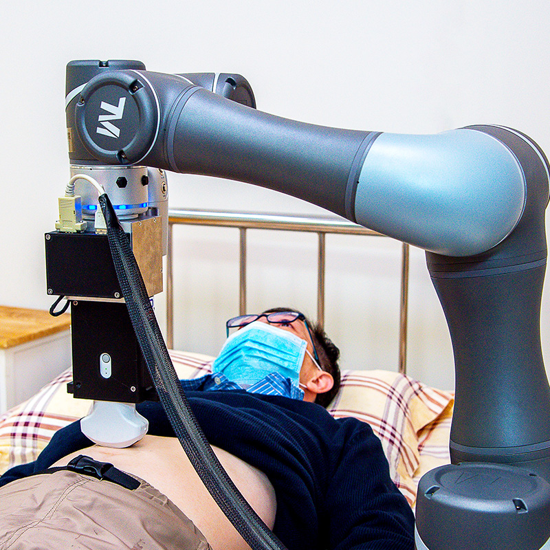 The robotic arm performs an abdominal ultrasound examination.