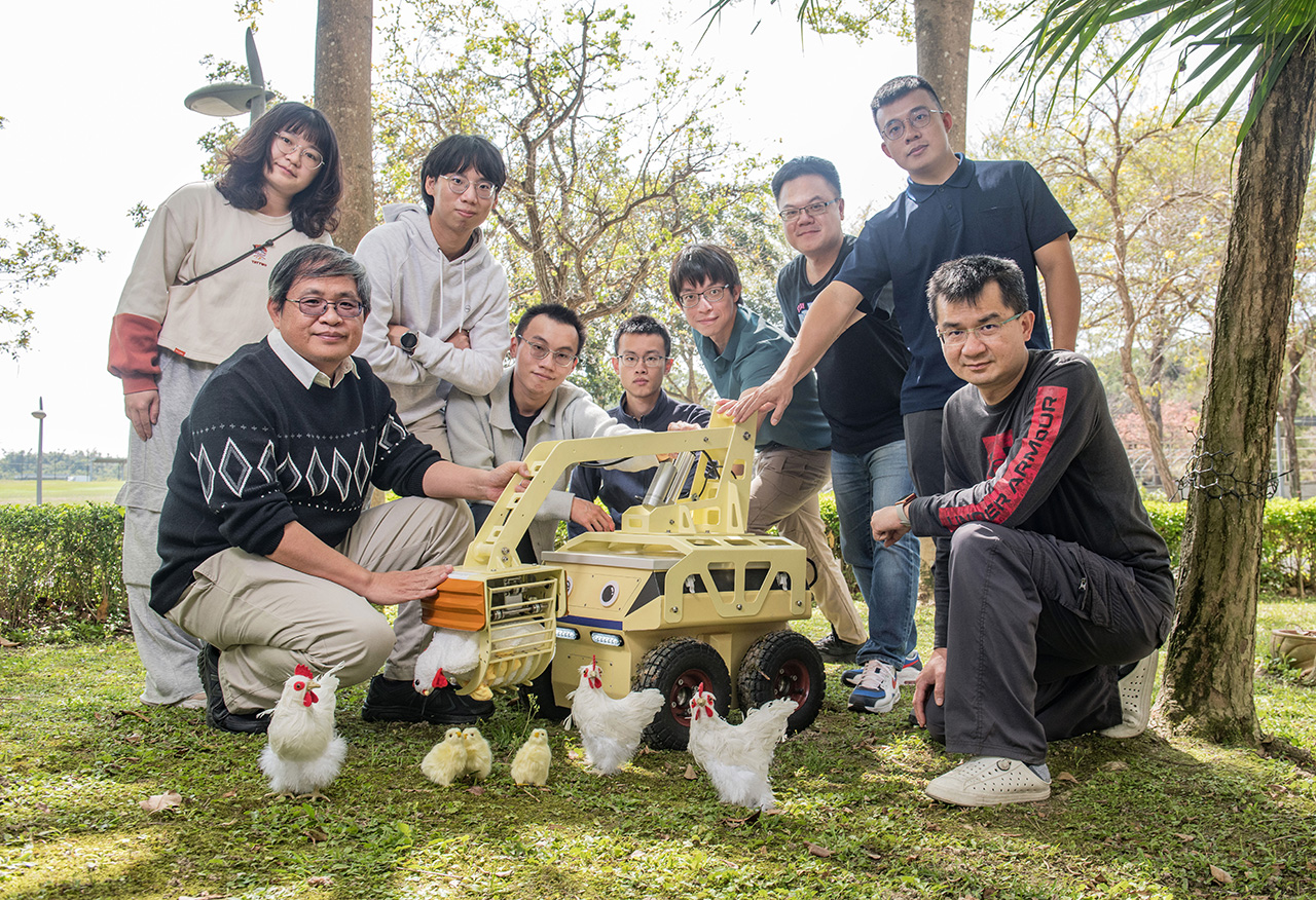 Researchers pose with the autonomous mobile robot developed for poultry house inspection.